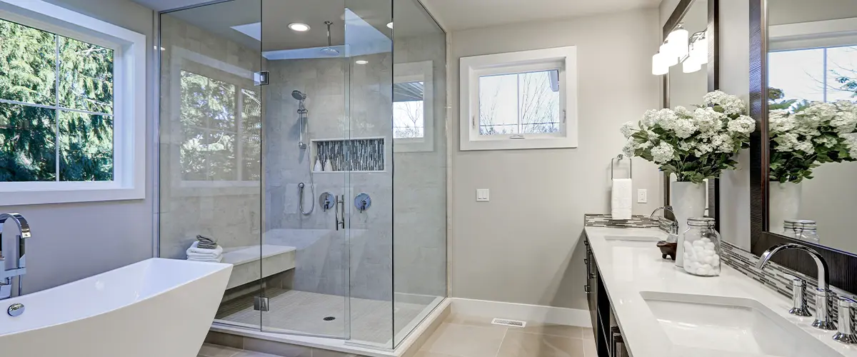 White bathroom with bathtub and shower cabin.