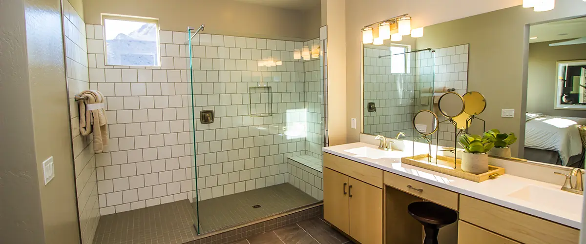 Bathroom in warm light with cabinets and walk in shower