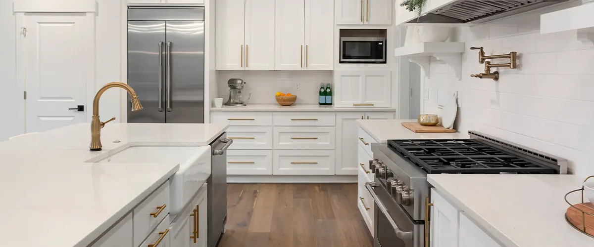 Beautiful kitchen detail in new luxury home. Features island, pendant lights, hardwood floors, and stainless steel appliances