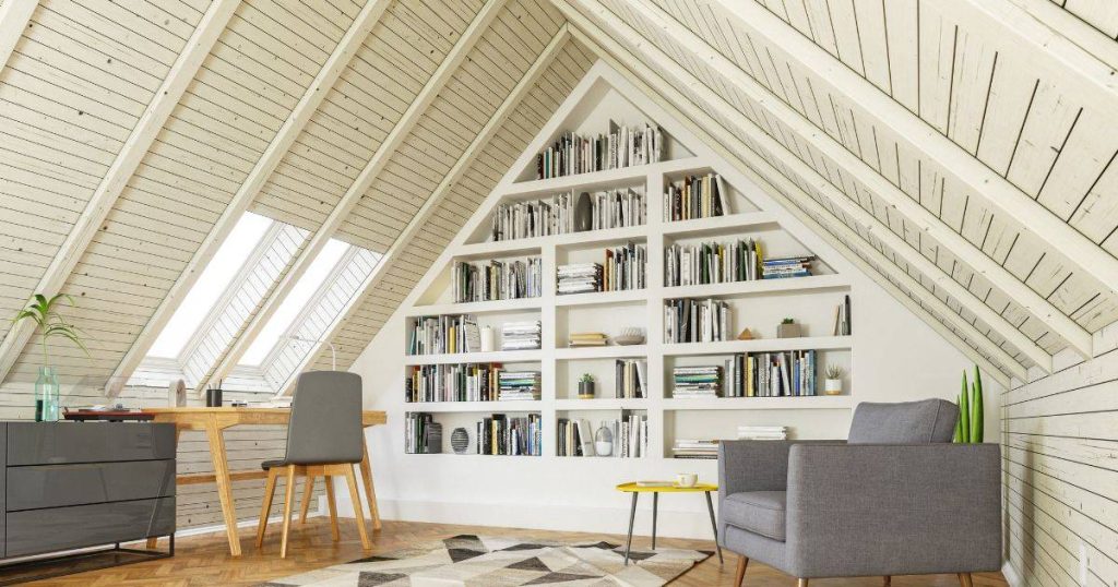 A stylish attic reading nook with built-in bookshelves, a sloped ceiling, and a cozy chair.