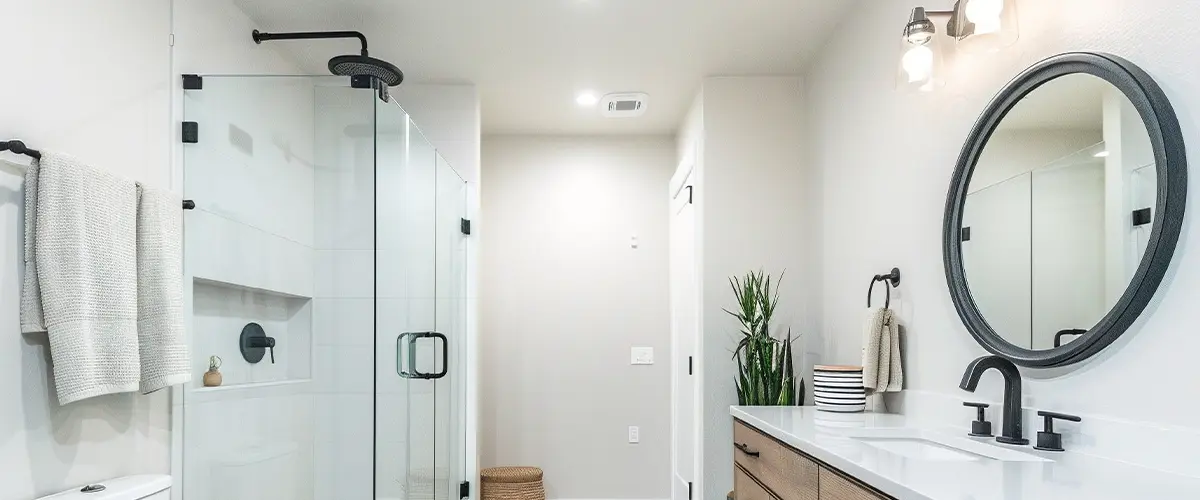 Contemporary bathroom with glass shower, rustic wood vanity, black fixtures, and minimalist decor